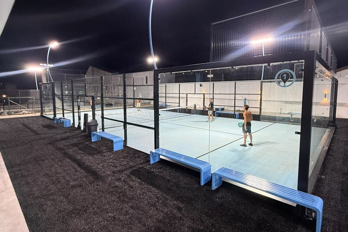 Players on the floodlit open-air court at night